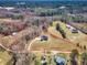 This aerial shot highlights the estate's boundaries, featuring a home, pond, acreage and the surrounding trees and property at 3608 Buzzard Rd, Wendell, NC 27591