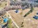 Beautiful aerial view of a home with an in-ground swimming pool and a long driveway, surrounded by vast acreage at 3608 Buzzard Rd, Wendell, NC 27591