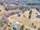 An aerial view of a home with a pool and pond amid a community, blending tranquility with community living at 3608 Buzzard Rd, Wendell, NC 27591