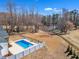 An aerial view showcases the sparkling blue pool area and adjacent pond at 3608 Buzzard Rd, Wendell, NC 27591