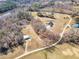 Birds-eye-view of a private house with a pond, and plenty of wooded acreage at 3608 Buzzard Rd, Wendell, NC 27591