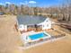 An aerial view showcases a pool and a charming home with a screened in porch at 3608 Buzzard Rd, Wendell, NC 27591