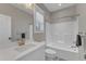 Bright bathroom features patterned tile floor, a white vanity, and a shower-tub combo with white tile at 3608 Buzzard Rd, Wendell, NC 27591