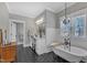 Stylish bathroom with a clawfoot tub, elegant vanity, and modern black-and-white flooring at 3608 Buzzard Rd, Wendell, NC 27591