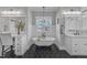 Bright bathroom with a clawfoot tub, black and white floors, and modern fixtures at 3608 Buzzard Rd, Wendell, NC 27591