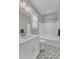 A bathroom with patterned tile floor, a white vanity, and a shower-tub combo with white tile at 3608 Buzzard Rd, Wendell, NC 27591