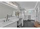 Bright bathroom featuring a double vanity, glass shower, and modern lighting at 3608 Buzzard Rd, Wendell, NC 27591