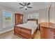 Bedroom with hardwood floors, ceiling fan, natural light, and wood furniture at 3608 Buzzard Rd, Wendell, NC 27591