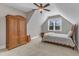 Bedroom showcases a wooden armoire, a charming bed, and a window framed by a white trimmed A-frame at 3608 Buzzard Rd, Wendell, NC 27591