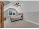 Bright bedroom featuring vaulted ceilings, ceiling fan, and a cozy window nook with natural light at 3608 Buzzard Rd, Wendell, NC 27591