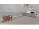 Bonus room includes a seating area and an adjacent table with chairs, all beneath a vaulted ceiling at 3608 Buzzard Rd, Wendell, NC 27591
