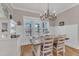 Bright dining room with natural light, chandelier, white trim, and views of the porch at 3608 Buzzard Rd, Wendell, NC 27591