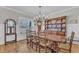 Elegant dining area with a large table, wooden hutch, and plenty of natural light from a window at 3608 Buzzard Rd, Wendell, NC 27591