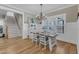 Light-filled dining room with hardwood floors, staircase, and table set for dining at 3608 Buzzard Rd, Wendell, NC 27591