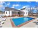 Exterior elevation featuring in-ground swimming pool, patio, and screened-in porch at 3608 Buzzard Rd, Wendell, NC 27591