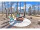Custom brick fire pit with seating area in wooded backyard at 3608 Buzzard Rd, Wendell, NC 27591