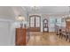 Stylish foyer with a wooden dresser, hardwood floors, and a view of the entry door and adjacent dining area at 3608 Buzzard Rd, Wendell, NC 27591