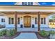 Inviting front porch featuring wood columns, a double door, and manicured landscaping enhancing the home's curb appeal at 3608 Buzzard Rd, Wendell, NC 27591
