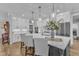 Bright kitchen featuring white cabinetry, stainless steel appliances, and a large marble island with seating at 3608 Buzzard Rd, Wendell, NC 27591