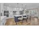 Open concept kitchen featuring white cabinetry, stainless appliances, and a large center island with seating at 3608 Buzzard Rd, Wendell, NC 27591