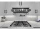 Close up of gas range top with stainless hood and pot filler at 3608 Buzzard Rd, Wendell, NC 27591