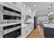 Updated kitchen with stainless double ovens, gas cooktop, white cabinets, and tile backsplash at 3608 Buzzard Rd, Wendell, NC 27591