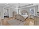Spacious main bedroom with tray ceiling, hardwood floors, and attached bathroom at 3608 Buzzard Rd, Wendell, NC 27591