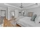 Charming bedroom featuring tray ceiling, hardwood floors, and a view into the bathroom at 3608 Buzzard Rd, Wendell, NC 27591