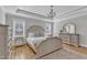Bright main bedroom with hardwood floors, a chandelier, and neutral decor at 3608 Buzzard Rd, Wendell, NC 27591