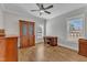Well-lit home office featuring wood floors, ceiling fan, desk, and abundant natural light at 3608 Buzzard Rd, Wendell, NC 27591