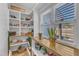 Pantry with window and natural light. Shelves full of food and supplies at 3608 Buzzard Rd, Wendell, NC 27591