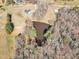 Aerial shot of a pond surrounded by trees and greenery, enhancing the natural beauty of the property at 3608 Buzzard Rd, Wendell, NC 27591