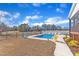 Backyard featuring a swimming pool, fence, trees, and some seating at 3608 Buzzard Rd, Wendell, NC 27591