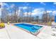 Backyard view of swimming pool, patio, and adjacent wooded area at 3608 Buzzard Rd, Wendell, NC 27591