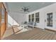 Inviting outdoor living space with comfortable seating, ceiling fan, and a blue-painted ceiling at 3608 Buzzard Rd, Wendell, NC 27591