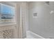 Shower featuring subway tile, shower curtain, and window for natural light at 3608 Buzzard Rd, Wendell, NC 27591