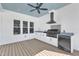 Outdoor summer kitchen features stainless steel appliances, granite countertops, and ample storage at 3608 Buzzard Rd, Wendell, NC 27591