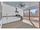 Outdoor summer kitchen with stainless steel grill and a view of the backyard pool from the screened porch at 3608 Buzzard Rd, Wendell, NC 27591