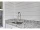 Wet bar featuring a stainless steel sink, gooseneck faucet, and granite countertops at 3608 Buzzard Rd, Wendell, NC 27591