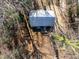 Aerial view of property surrounded by trees with a metal roof, porch, and lush greenery at 365 Shawnee Dr, Louisburg, NC 27549