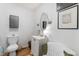 Cozy half bath with decorative mirror, vanity, and lighting at 365 Shawnee Dr, Louisburg, NC 27549