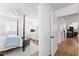 Bright bedroom featuring a four poster bed, white walls, and views to the hallway and home's kitchen at 365 Shawnee Dr, Louisburg, NC 27549