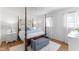 Primary bedroom featuring a four poster bed and stylish decor at 365 Shawnee Dr, Louisburg, NC 27549