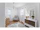 Cozy bedroom with a patterned rug, decorative chandelier, and ample natural light at 365 Shawnee Dr, Louisburg, NC 27549