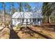 Charming cottage-style home featuring a metal roof, black shutters, and inviting front porch at 365 Shawnee Dr, Louisburg, NC 27549