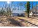 Exterior view of home showing the home's siding, metal roof and deck surrounded by mature trees at 365 Shawnee Dr, Louisburg, NC 27549