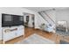 Cozy living room with stylish seating, decor, stairs to the second level, and wood-look flooring at 365 Shawnee Dr, Louisburg, NC 27549