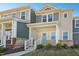 Charming townhome featuring a light yellow exterior with a welcoming covered front porch at 3725 Rosebush Dr, Zebulon, NC 27597