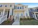 Charming townhome featuring a light yellow exterior with a welcoming covered front porch at 3725 Rosebush Dr, Zebulon, NC 27597