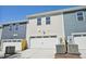 The front of the two-car garage features modern lighting at 3725 Rosebush Dr, Zebulon, NC 27597